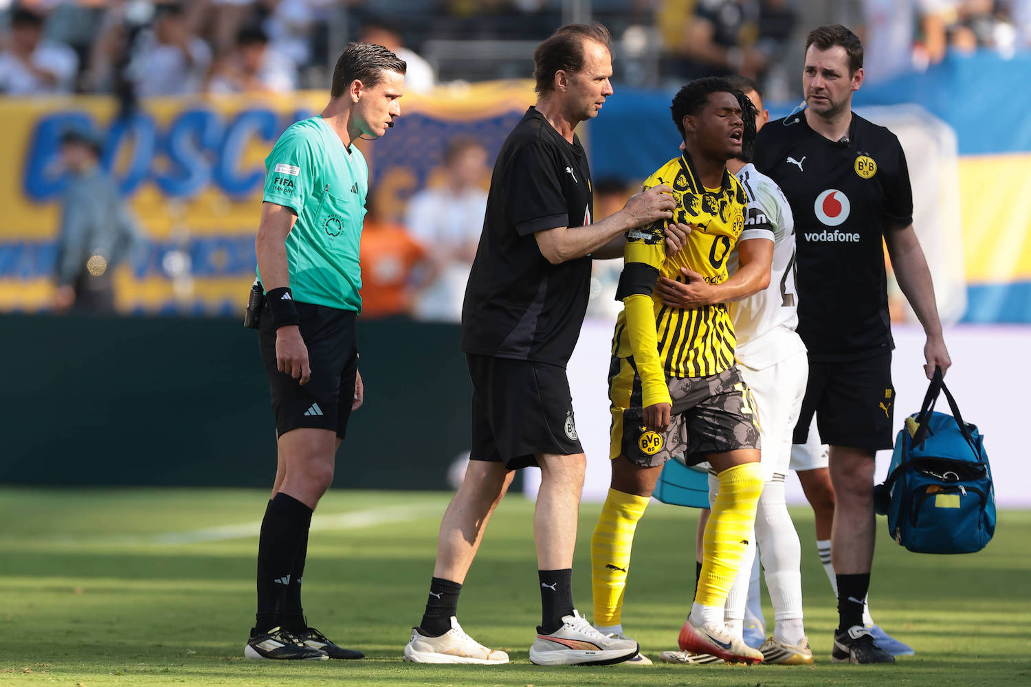New Jersey, USA, 5th July 2025. Fran Garcia of Real Madrid embraces Julien Duranville of Borussia Dortmund as he leaves the field of play with medical staff after picking up an injury in a clash with the Spanish full back during the Real Madrid vs Borussia Dortmund FIFA Club World Cup match at Metlife Stadium, New Jersey. Picture credit should read: Jonathan Moscrop / Sportimage EDITORIAL USE ONLY. No use with unauthorised audio, video, data, fixture lists, club/league logos or live services. Online in-match use limited to 120 images, no video emulation. No use in betting, games or single club/league/player publications. SPI_101_JM_REALMADRID_BORUSSIA_ SPI-4005-0101